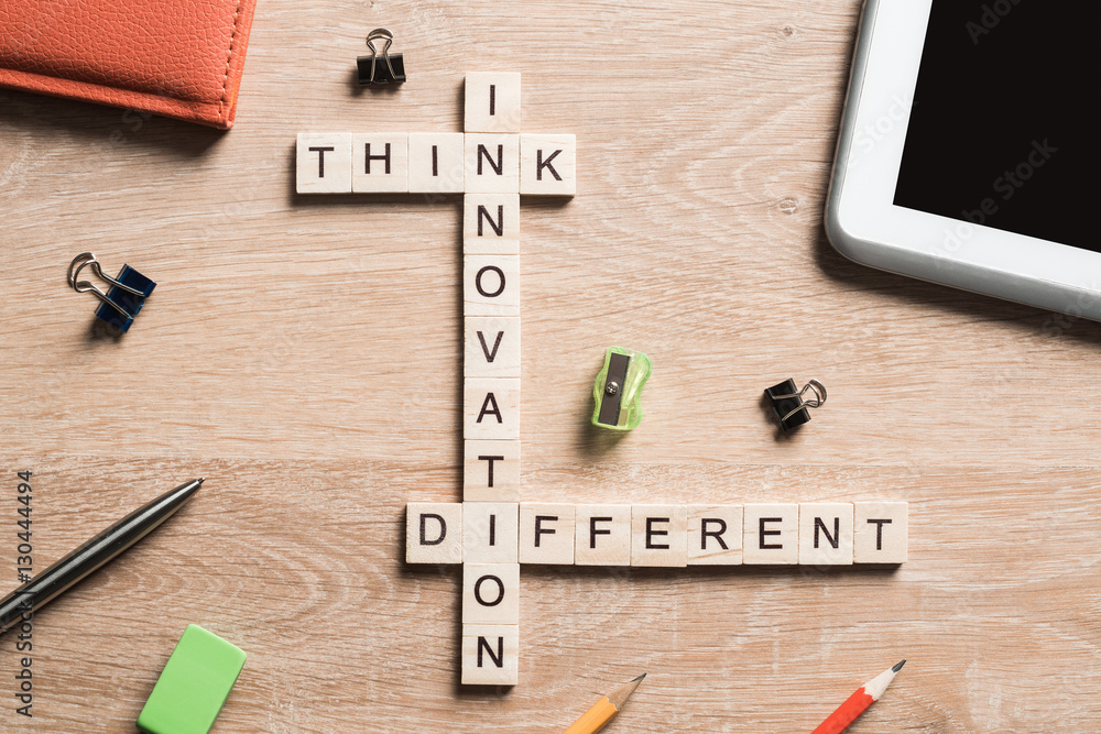 Think different concept of crossword puzzle on wooden surface or table Think different concept of crossword puzzle on wooden surface or table