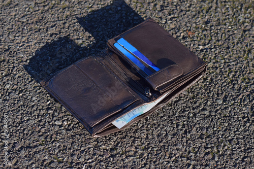 The lost wallet with cash and credit cards on the street 