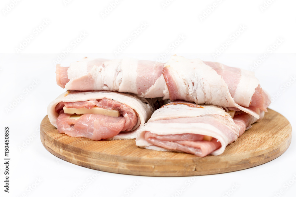 Stuffed pork chop with yellow cheese and rolled in bacon over wh Stuffed pork chop with yellow cheese and rolled in bacon over wh