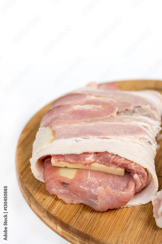 Stuffed pork chop with yellow cheese and rolled in bacon over wh Stuffed pork chop with yellow cheese and rolled in bacon over wh