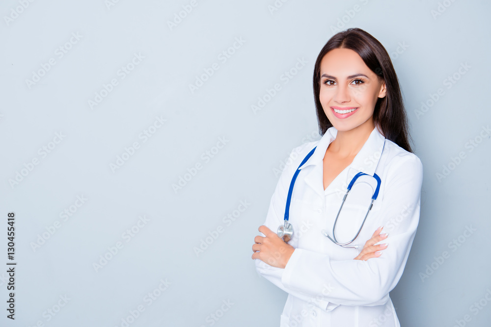 Cheerful happy doctor with crossed hands on blue background Cheerful happy doctor with crossed hands on blue background