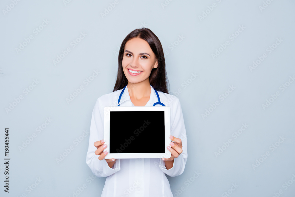 Pretty young doctor demonstrating black screen of tablet Pretty young doctor demonstrating black screen of tablet