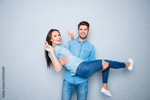 Happy man having fun and carrying his girlfriend