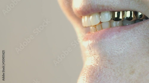 Mouth of elderly woman with false teeth. Close up photo