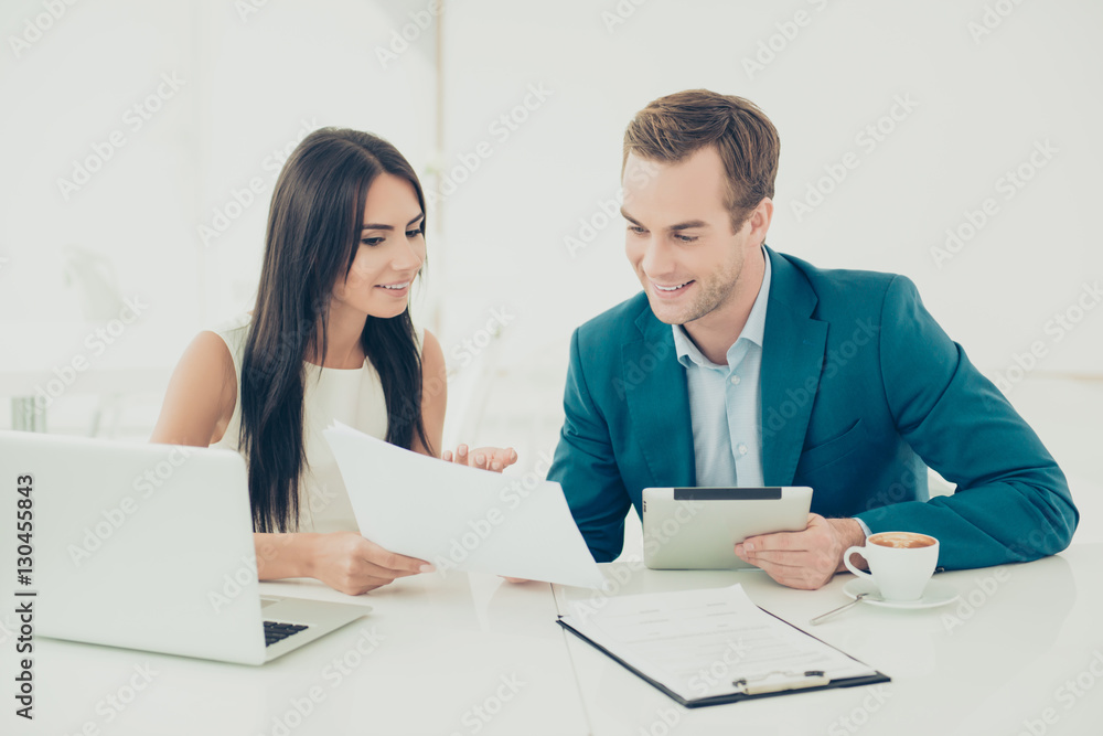 Two young business people working on new important contract Two young business people working on new important contract