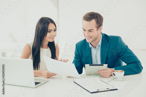 Two young business people working on new important contract
