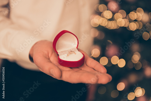 Close up photo of man holding box with wedding ring