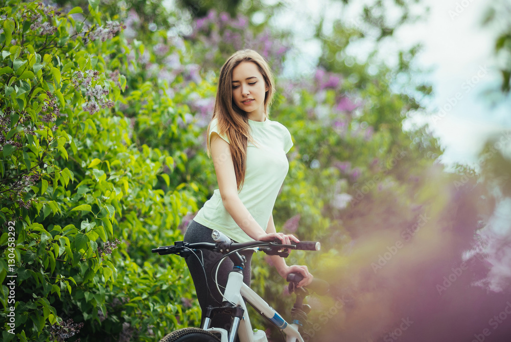 Happy young girl cyclist standing with a mountain bike and. Adventure travel. Girl cyclist. Mountain bike. healthy lifestyle. Sort concept. Happy young girl cyclist standing with a mountain bike and. Adventure travel. Girl cyclist. Mountain bike. healthy lifestyle. Sort concept.