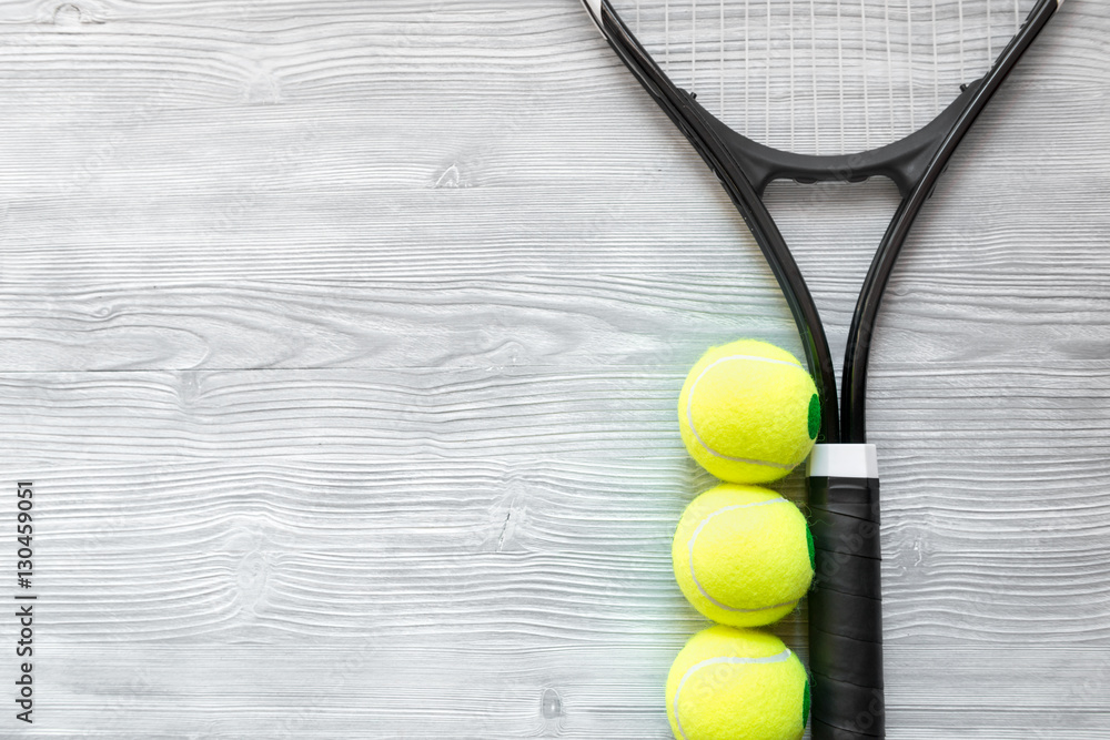 tennis racket on wooden background top view