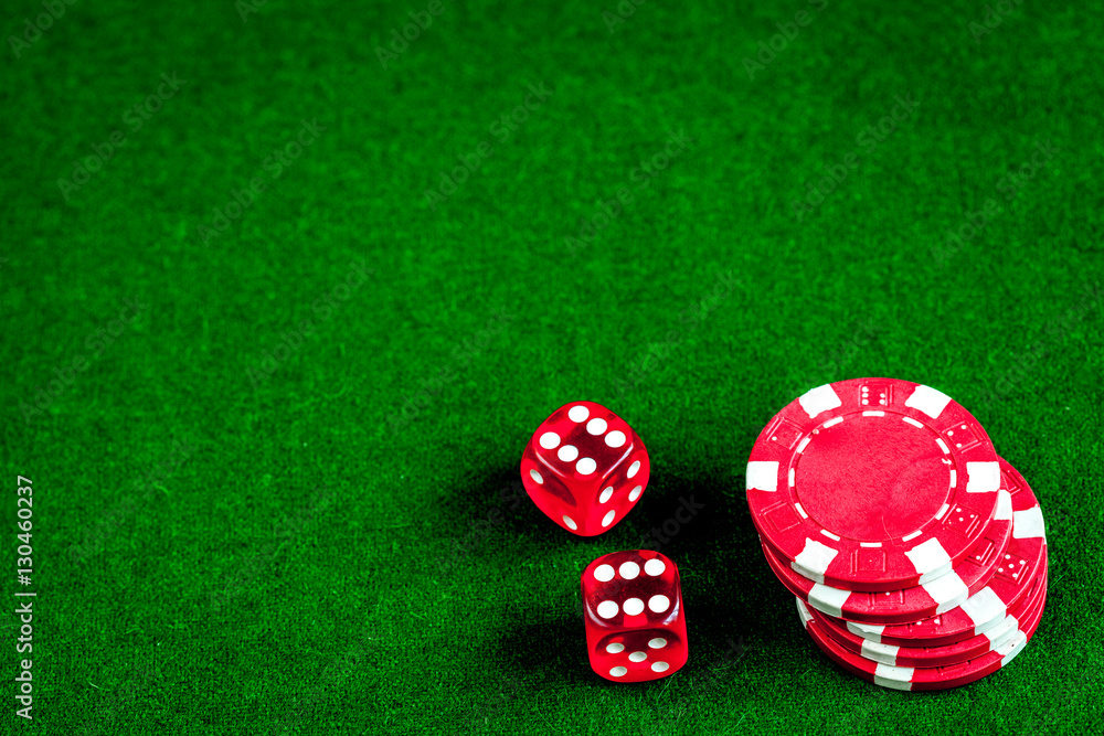 poker chips and dice on green background top view poker chips and dice on green background top view