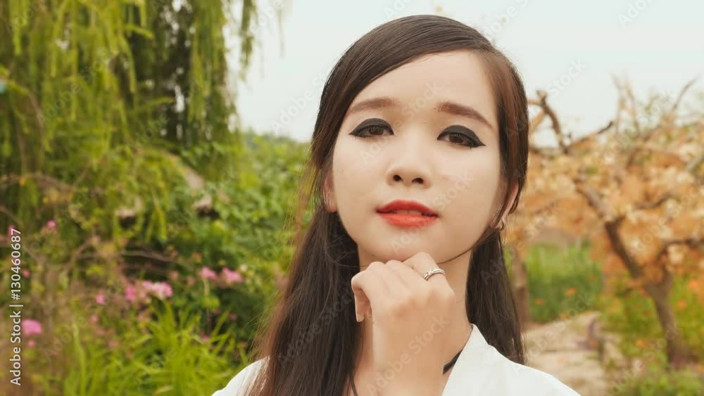 Portrait of a young vietnamese asian girl looking at camera. Strong makeup. Portrait of a young vietnamese asian girl looking at camera. Strong makeup.