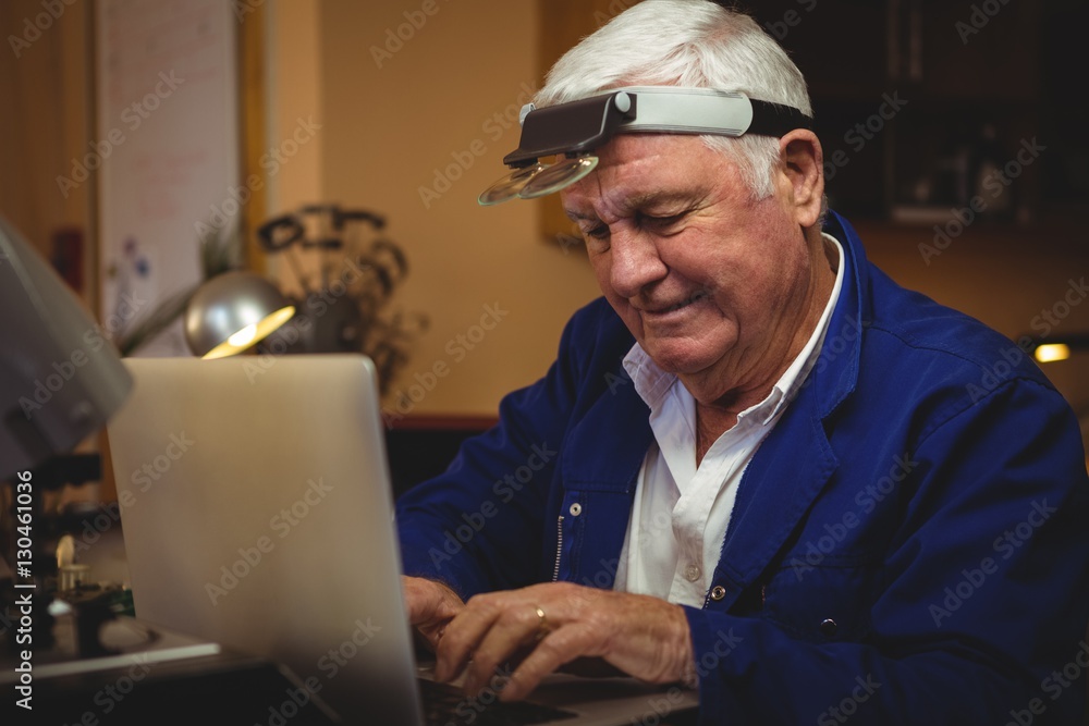 Horologist working on laptop Horologist working on laptop