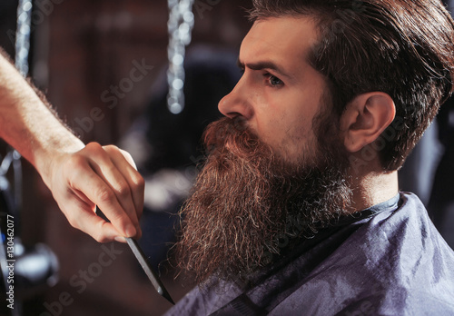 Handsome bearded man in barbershop photo