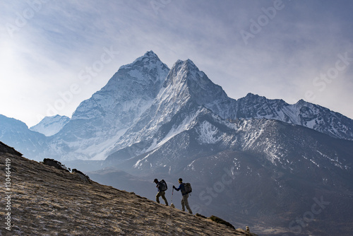 Trekkers climb a small peak above Dingboche in the Everest region in time to see the sunrise, with Ama Dablam in the distance, Himalayas, Nepal