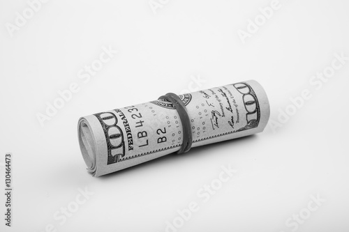 Close up shot of dollar roll tightened with band isolated on white background. Shoot in black and white shot.