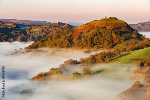The medieval castle Dinas Bran standing above the mist and fog on an autumn morning, Denbighshire, Wales photo