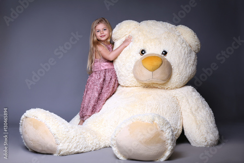Kid hugging big plush bear
