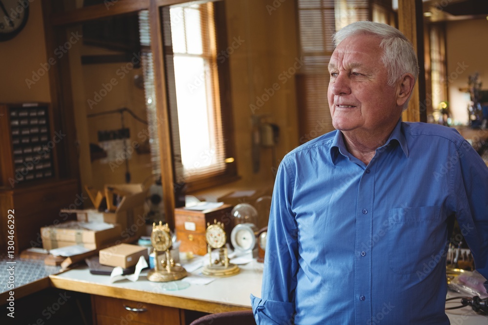 Horologist standing in workshop Horologist standing in workshop