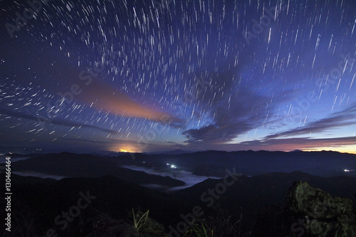Beautiful scenery of the startrail on sky at night at Doi Pha Phung at Nan province in Thailand. Long exposure shooting and high iso used make this photo have noise