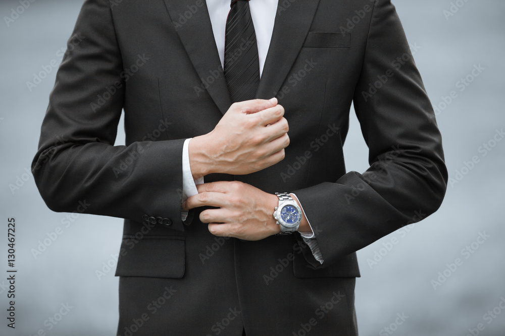 Obraz premium Closeup of man wearing suit and watch. 