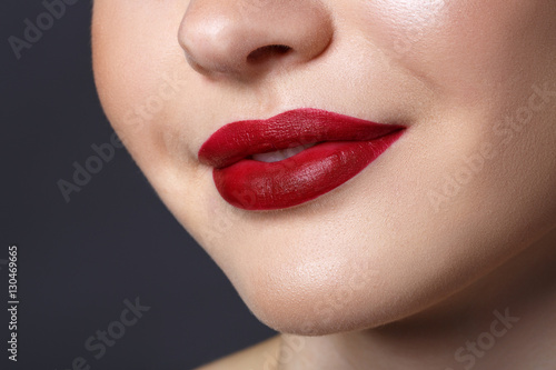 Close-up happy female smile with healthy white teeth  dark red matt lips make-up. Cosmetology  dentistry and beauty care.