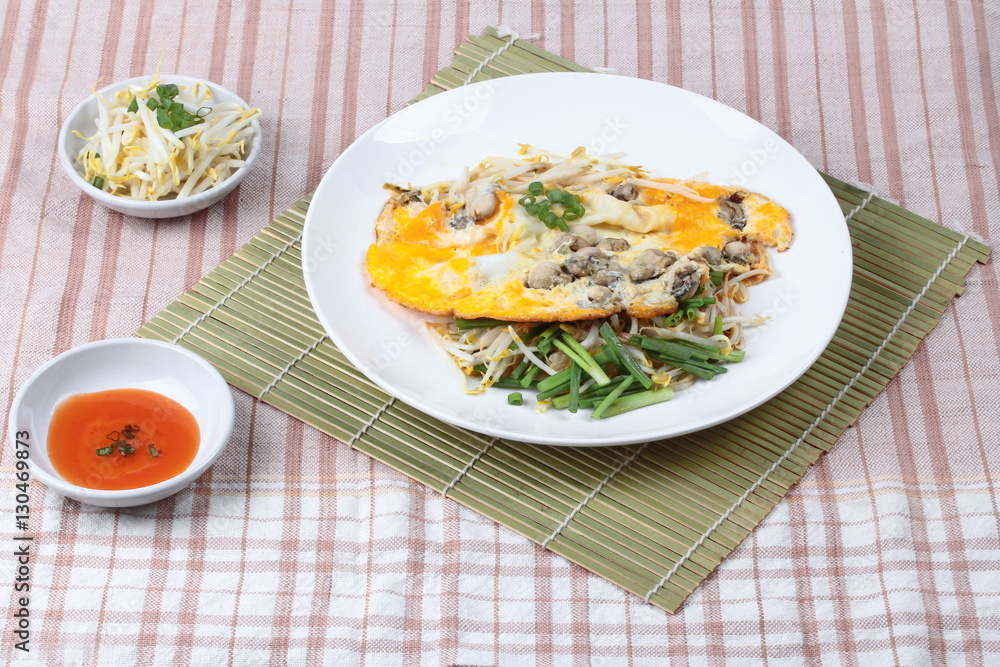 Oyster omelet with herb call Hoi Tod Khai in Thai . Oyster omelet with herb call Hoi Tod Khai in Thai .