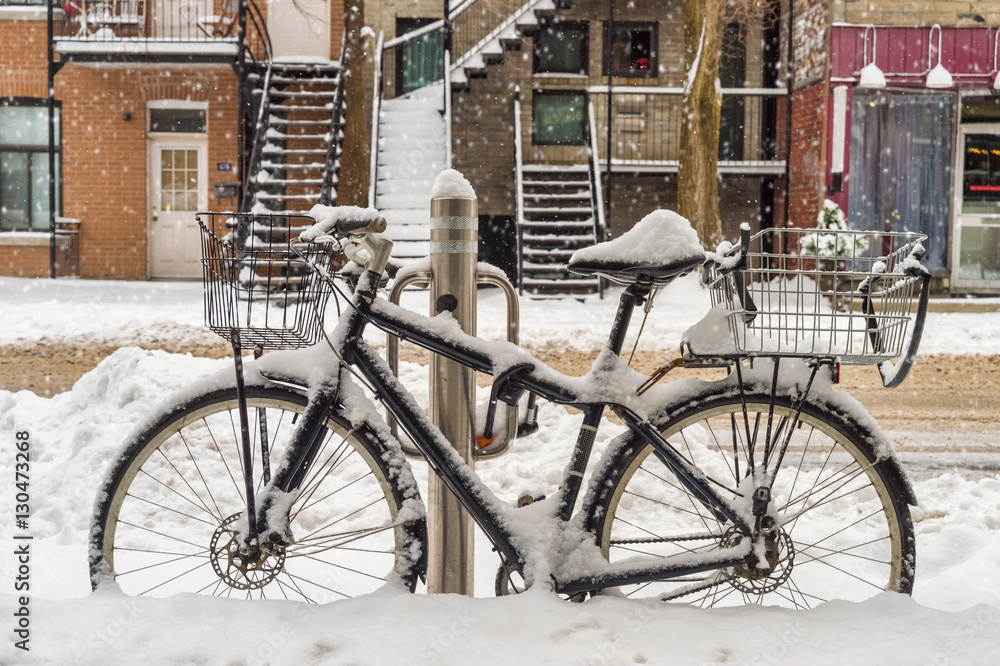 Bike covered with fresh snow in Montreal during snow storm (Dece