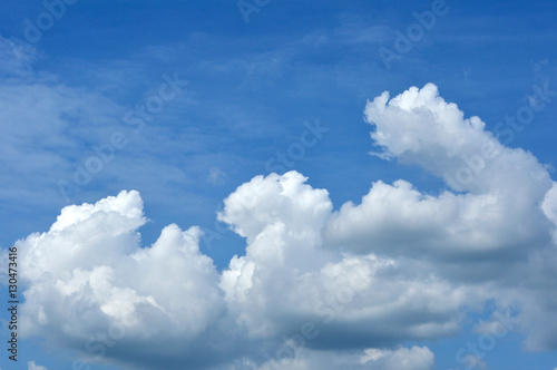 Blue sky with fluffy cloud for background.
