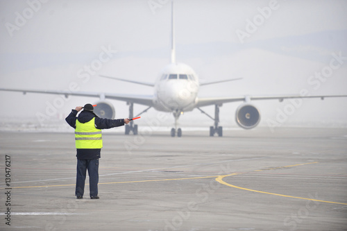 airport worker signaling