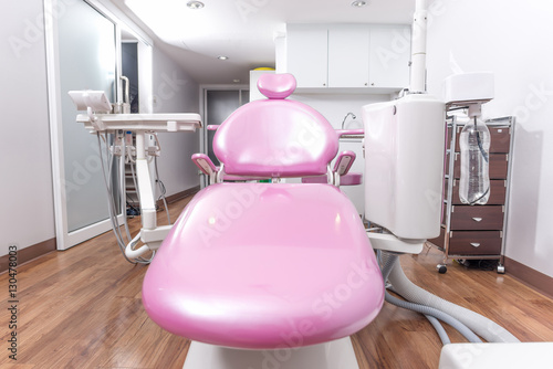 Dental office with pink dental chair..