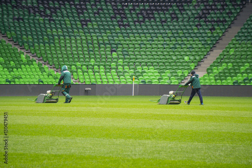 Mowing grass in a football stadium