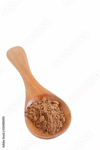 Carob Powder on Wooden Spoon on White Background