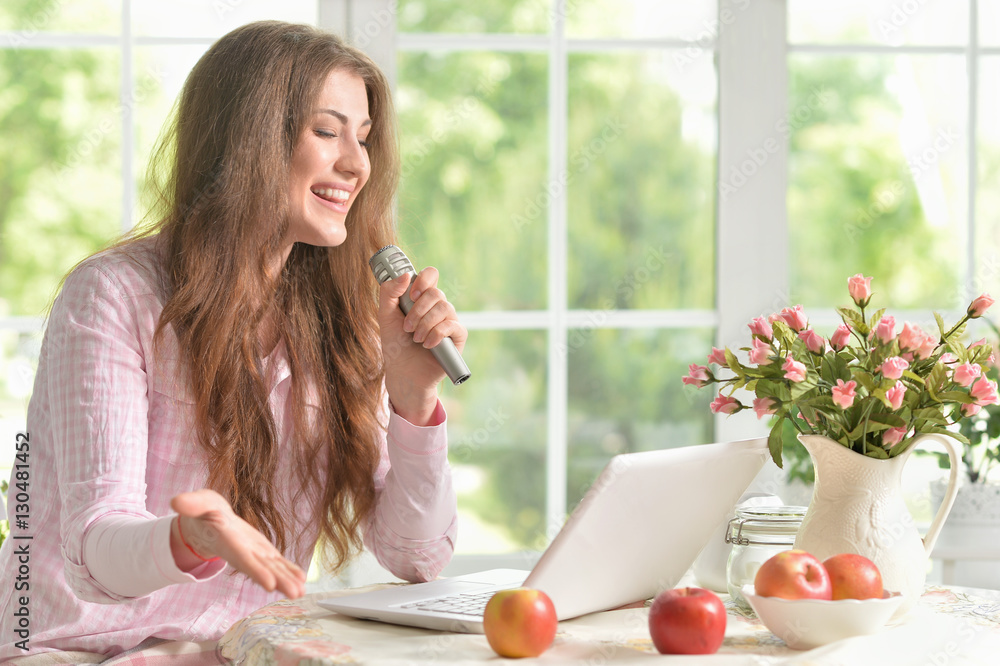 young woman with laptop and microphone young woman with laptop and microphone