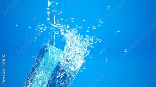 Beautiful glass, which poured cold water, blue background.