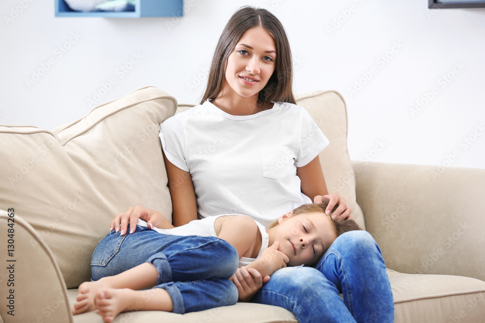 Cute girl lying on mothers knees at home Cute girl lying on mothers knees at home