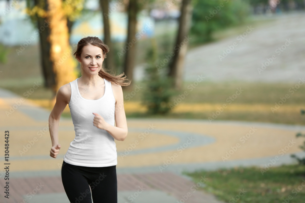 Young sporty woman jogging in a park Young sporty woman jogging in a park