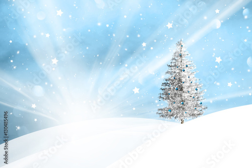 Winter snowy landscape with sun beams and with lovely snowy Christmas tree decoration background.