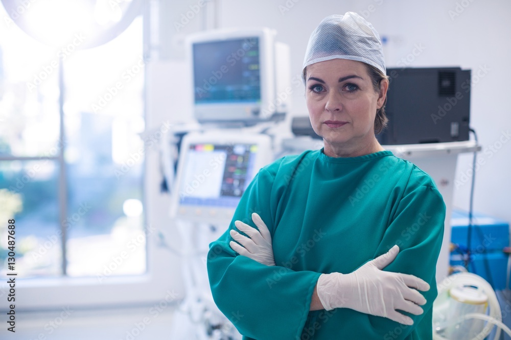 Female surgeon standing with arms crossed