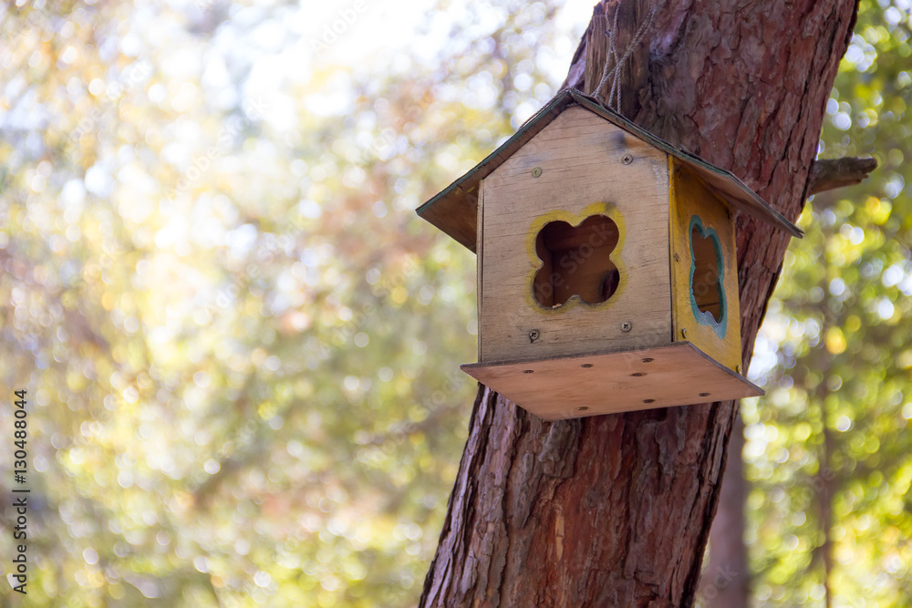 Wooden birdhouse on a tree.