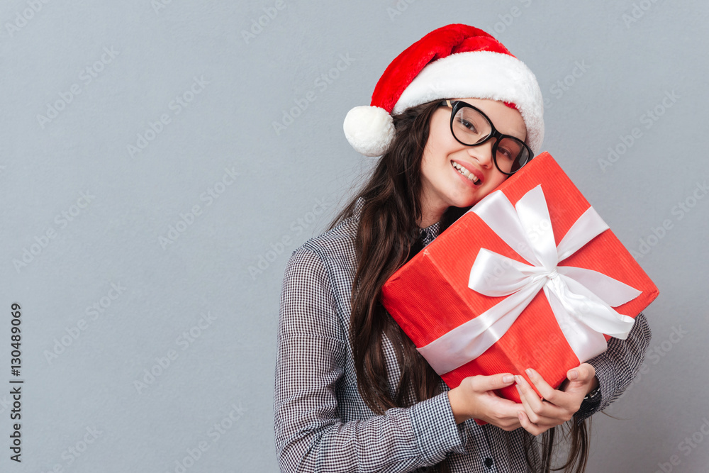 Asian girl in christmas hat with gift Asian girl in christmas hat with gift
