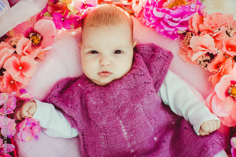 Incredible and charming newborn baby lying in floral basket Incredible and charming newborn baby lying in floral basket