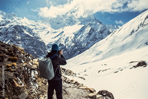 photographer taking picture of Himalayan mountain peak, peak of Machapuchare or Fishtail peak in Nepal, Napal... photo