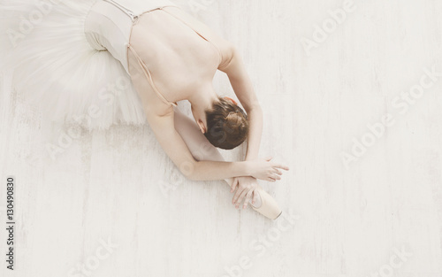 Graceful Ballerina stretching, ballet background, top view