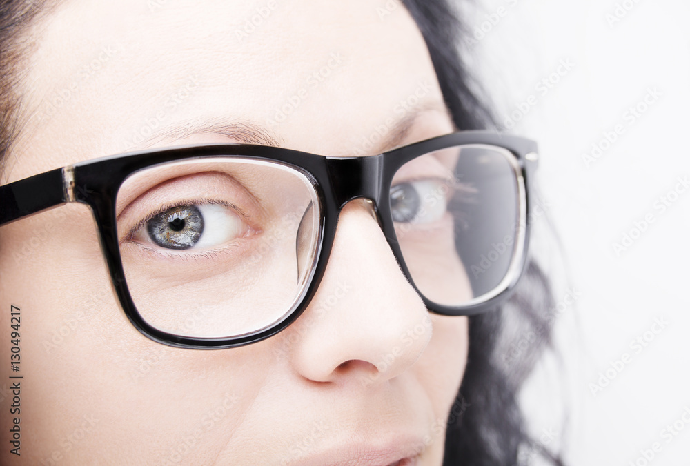 Beautiful young woman wearing glasses close-up isolated on white Beautiful young woman wearing glasses close-up isolated on white