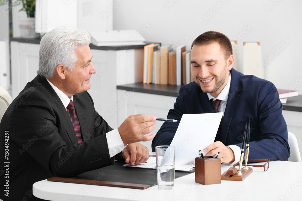 Young man with notary at office Young man with notary at office