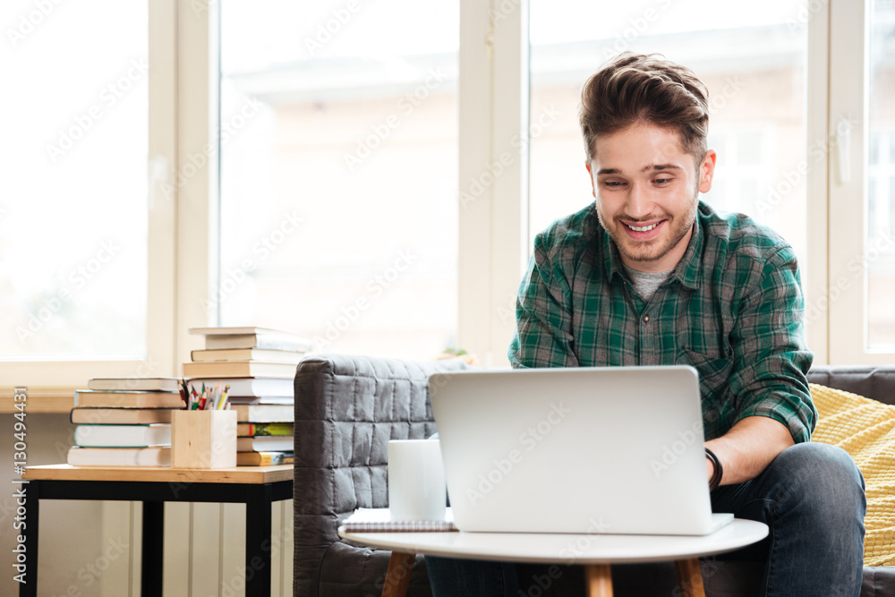 Man looking at laptop in office Man looking at laptop in office