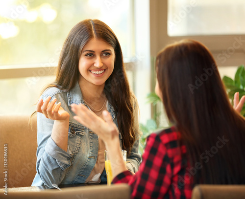 Cheerful young women sittin...