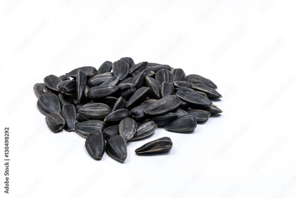 Closeup of a pile of sunflower seeds isolated on white background Closeup of a pile of sunflower seeds isolated on white background