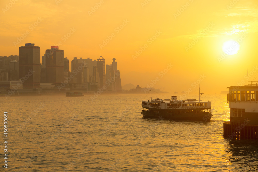 Star ferry passenger boats at sunset in victoria harbour, Hong kong