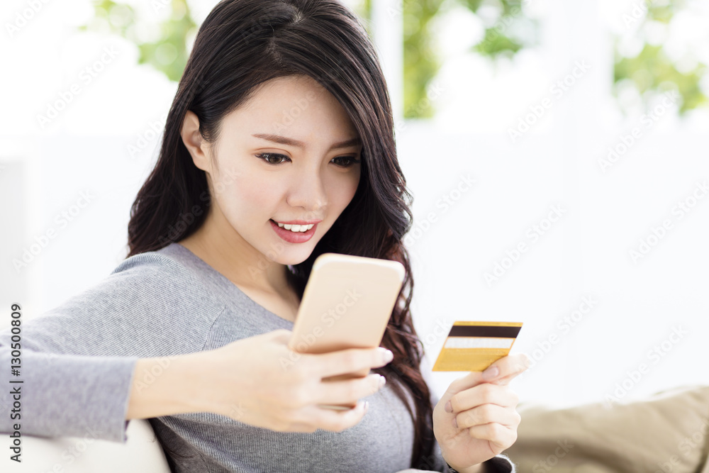 young beautiful woman with credit card and smart phone young beautiful woman with credit card and smart phone